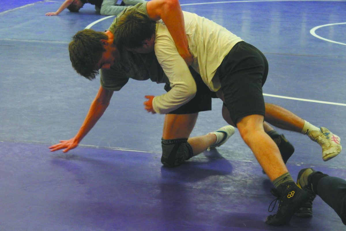 Meeting his match. During a boys wrestling practice on November 20, senior Lucas Perrin (left) wrestled fellow teammate junior Jason Hike (right) in the wrestling room at Bellevue East. The wrestling team uses their time on the mat to improve their wrestling techniques and build endurance that is needed for a 6-minute match at competition. “I didn’t want Jason to get my leg,” Perrin said. “I was trying to get his arms off my leg, turn around, and get behind him.” 