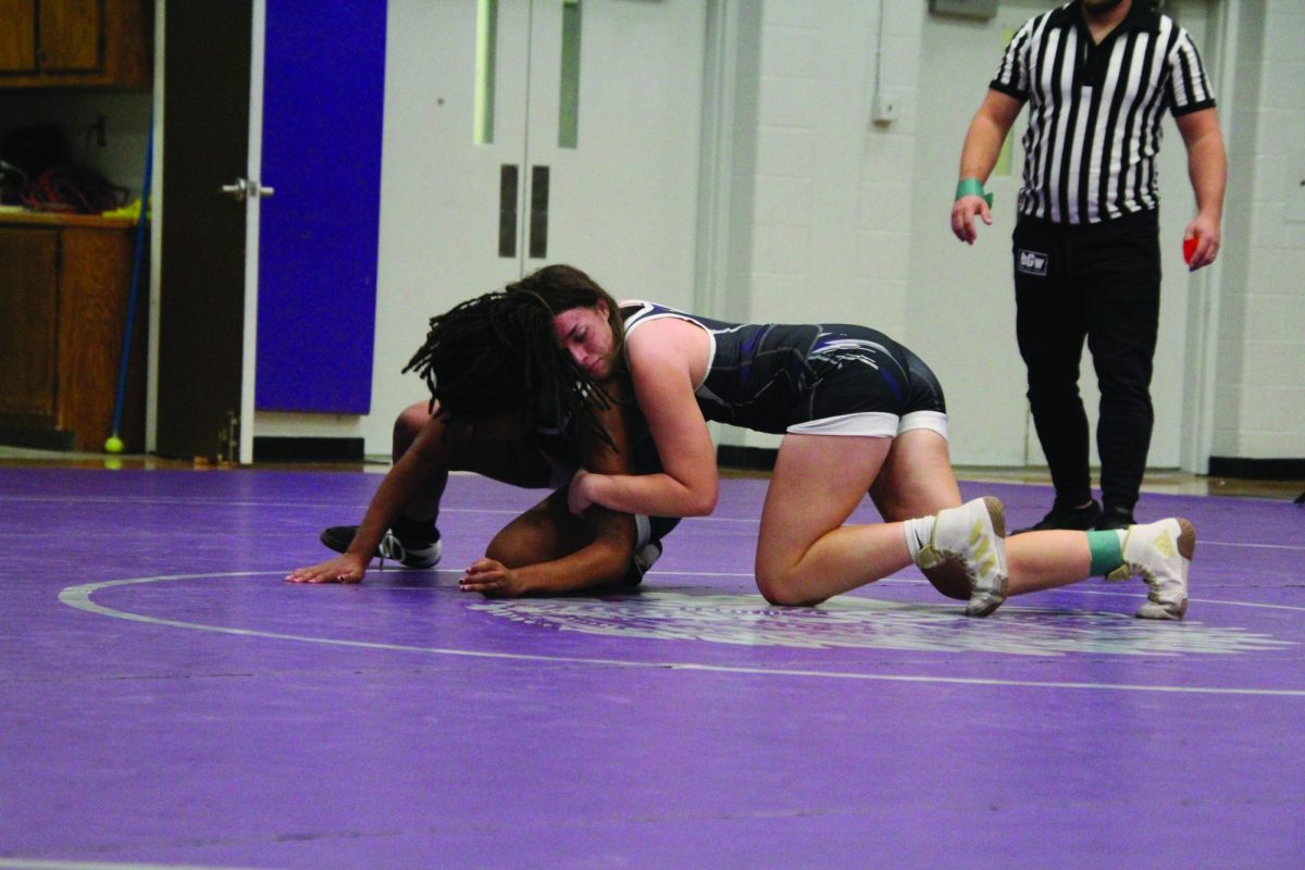 Pin her Down, During the Black and Purple scrimmage dual on Nov. 29, sophomore Makaela Davis, in purple, competes against fellow teammate senior Ally Cook, in black. The scrimmage was used to fundraise snacks fro teh girls wrestling team. “Wrestling seniors is scary,” Davis said.