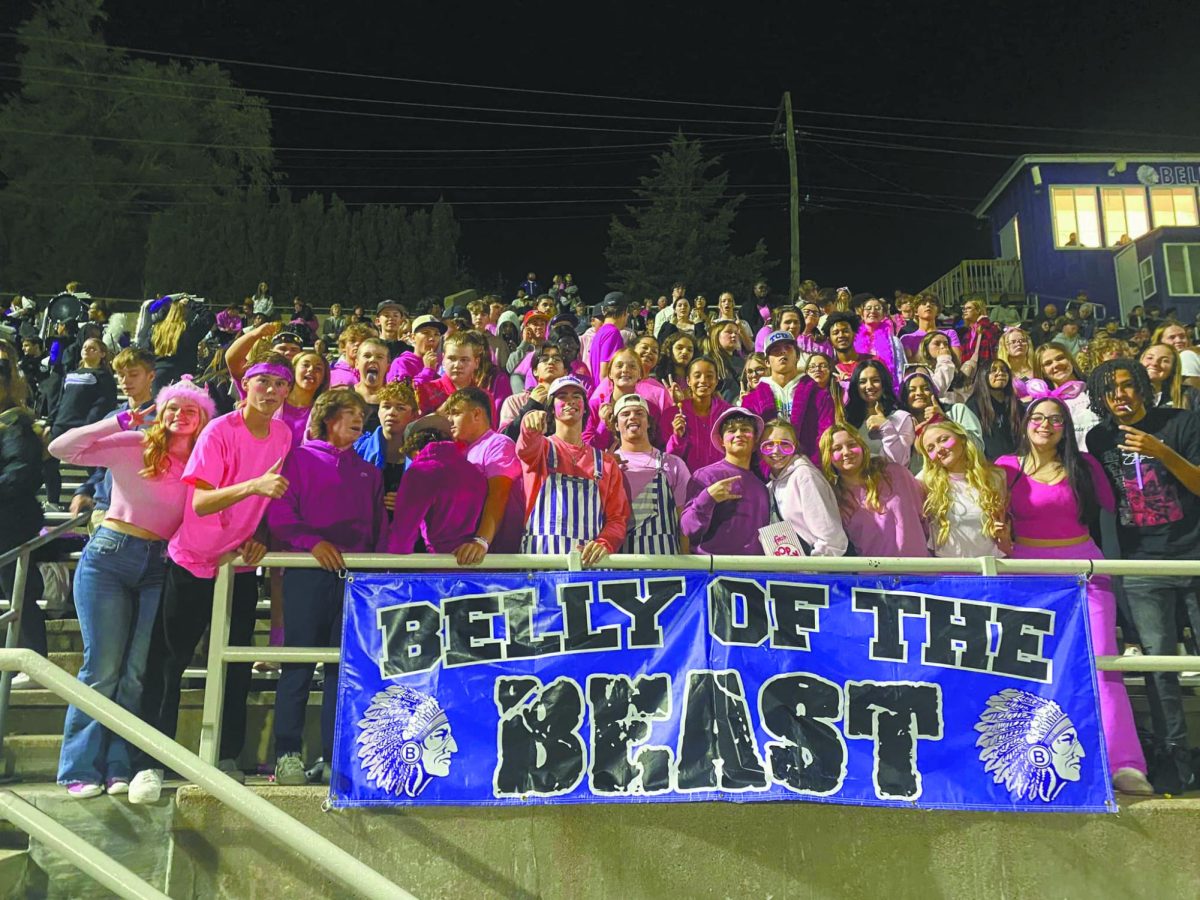 Loud and Proud! Senior Kael Walker guides the student section during a football game against Omaha South. “It was extremely enjoyable. I loved every part of it. Some of the responsibilities I had would have been leading the student sections in chants and getting people excited for the games,” Walker said. 
