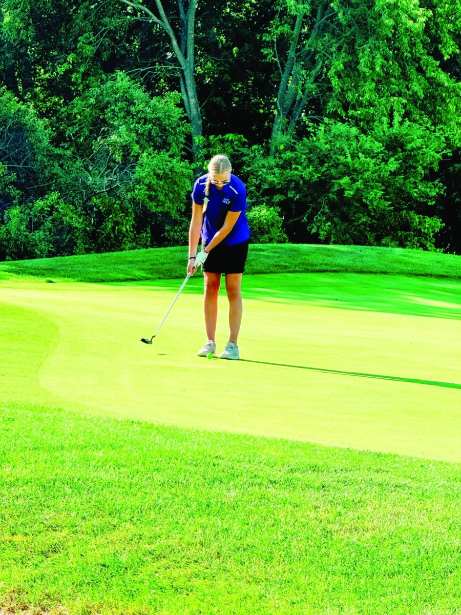 Perfect putt. At Tara Hills Golf Course sophomore Jazlin Reimer carefully putts the ball on the green. Every stroke counts so this finish will help her team win the Chieftain Invite. “I was excited to play again, I really like the course [at Tara Hills],” Reimer said. Photo courtesy of Nicole Burns 