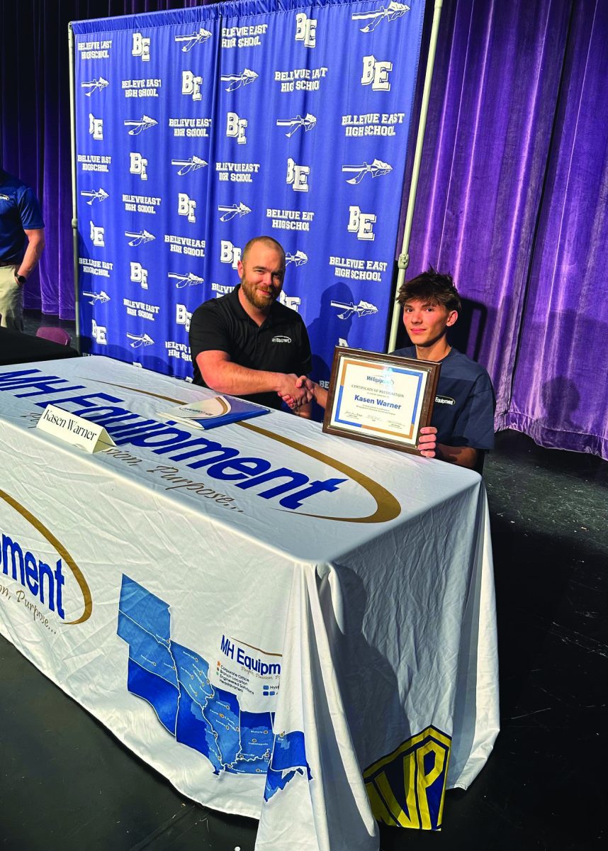 Smile! On April 8, 2025 at Bellevue East High School, junior Kasen Warner signed with MH Equipment. MH equipment is going to pay for their two year degrees in skilled and technical trade areas and pay for a full set of tools. “This opportunity helps me because I'm gonna be shadowing people and learning more about how to do it [do things in his trade],” Warner said.