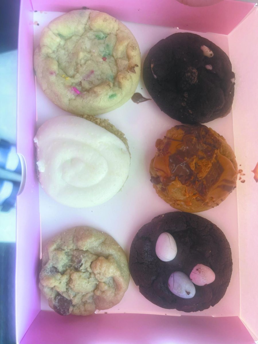 (LEFT TO RIGHT) Semi-Sweet chocolate chip cookie, Peanut Butter Cup Cookie ft. REESE’S, Vanilla Crumb Cake Cookie ft. GOLDEN OREO, Confetti Cookie, Chocolate Cookies & Cream Cookie, Carrot Cake, Raspberry Cheesecake.