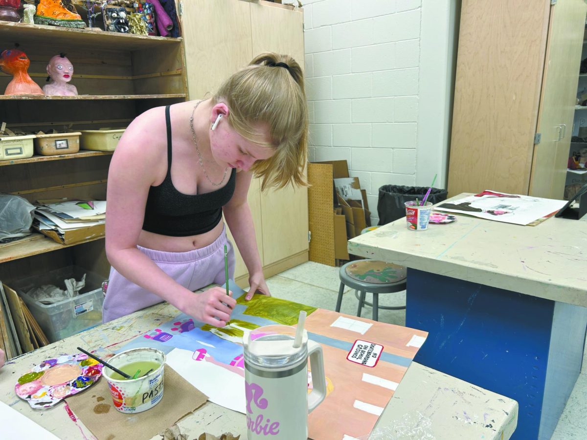 Hue go girl! Senior Carson Rollings focuses on blending colors for her painting. During springtime, she feels more inspired in her artistic endeavors and even anticipates creating more pieces soon. “I plan on spending a lot of my time outside while also drawing and painting what I see in my backyard,” Rollings said. 