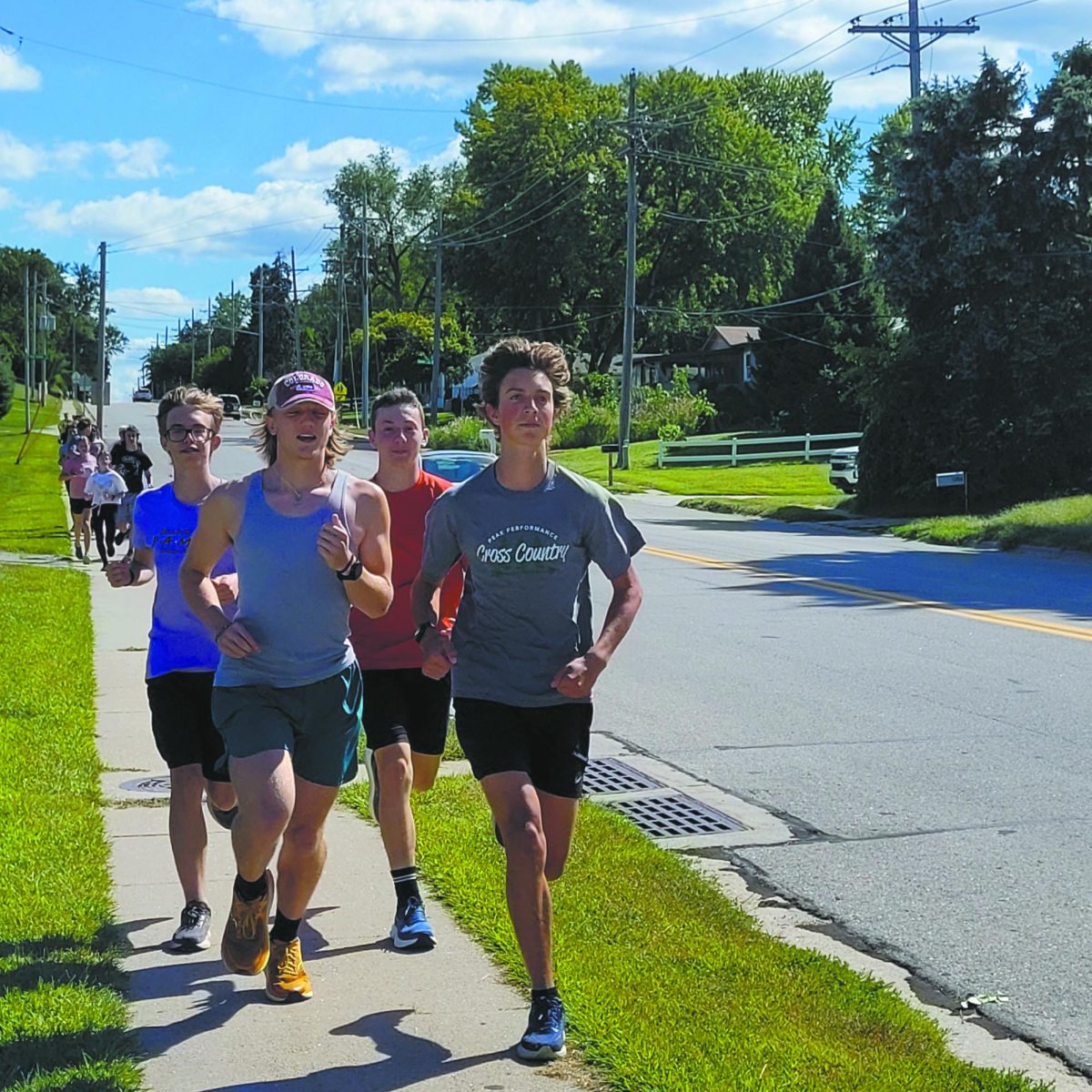 Pow. Feet pound the ground as sophomore Timothy Bogatz (RIGHT) and the East cross country team start their 5K run after school. Their breathless rhythm, however, never stopped them from making their support known to their teammates. “The team is always positive and encouraging, they tell you to keep going,” Bogatz said. 