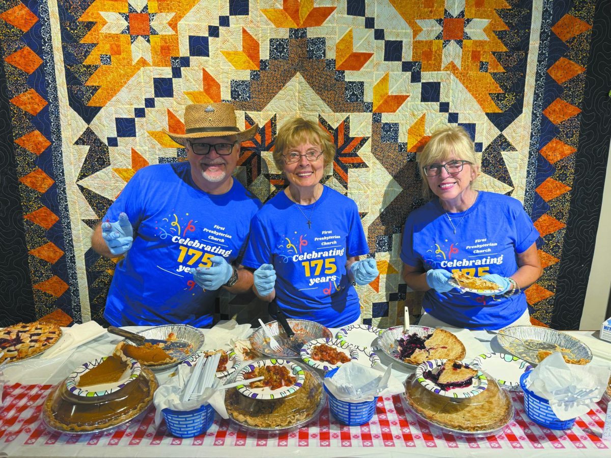 Plenty of pie. With a smile on her face, First Presbyterian Church member Joyce Wells serves visitors pie as they enter the Sarpy County Museum. This gathering concluded the 175th anniversary celebration of the First Presbyterian Church with tables to sit and eat at before exploring the displays of history. “We had a lot of good pie to serve so that was my favorite part,” Wells said.