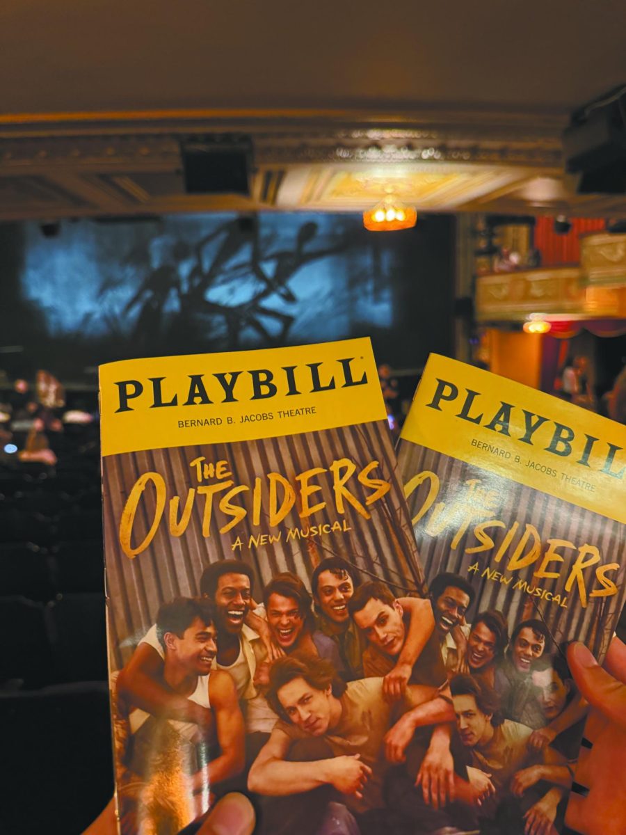 Tulsa 1967. At a July 2025 showing of “The Outsiders: A New Musical” at the Jacobs Theater in New York City, senior Victoria Bogatz holds up her playbill. “The Outsiders” will be showing at the Orpheum Theater in Omaha from September 28 to October 4. “‘The Outsiders’ is a grounded, gritty, and entirely believable musical,” Bogatz said.