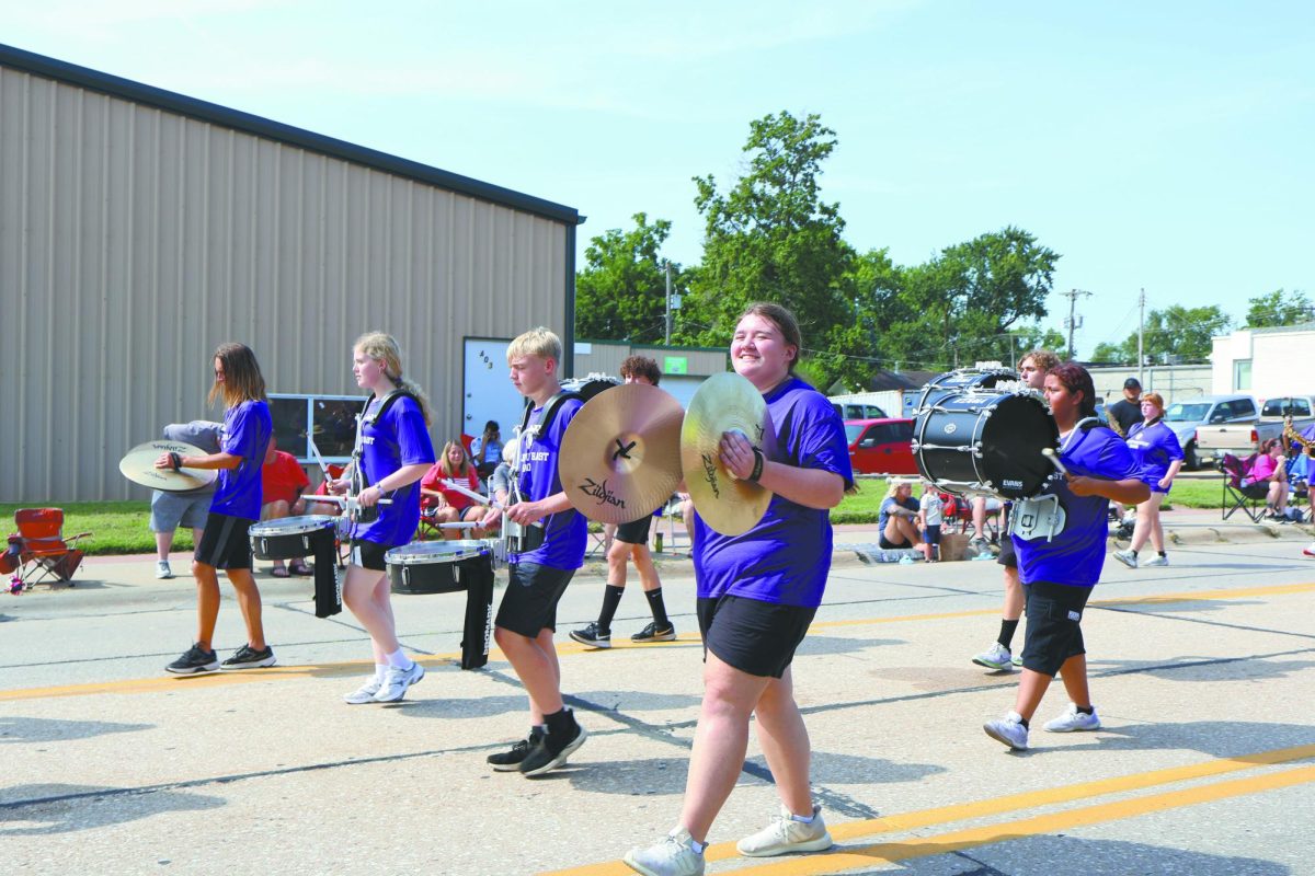 Clash. While at the parade, junior Sophia Skudler marches along with the drum line. Bellevue East’s drum line included snares, cymbals, and more. “We marched in the parade and the goal of the drum line is to be happy and hype the crowd up,” Skudler said.