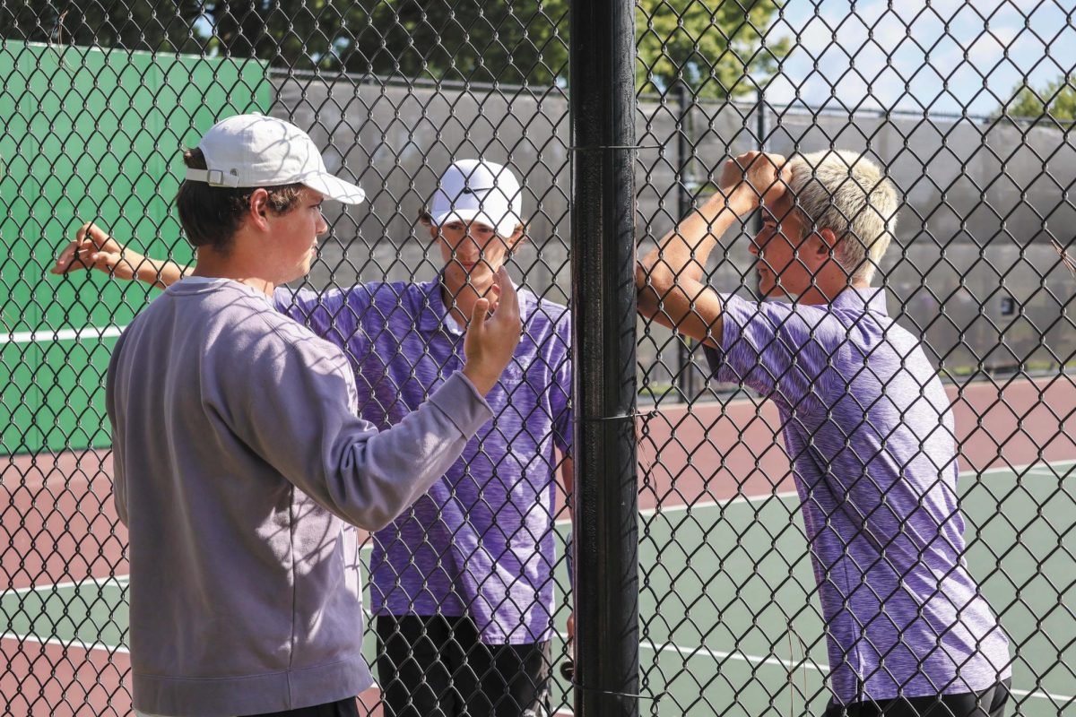 Changing the game. Head coach Benjamin Dalton [LEFT] talks to two tennis players, junior Taylor Jarrett and senior Leonidas Greaves [RIGHT] to coach them through a technique to make them better tennis players. Dalton was an assistant coach last year, but this is the first year he is head coach."The head coach has a lot more of getting everything in place," Dalton said. 