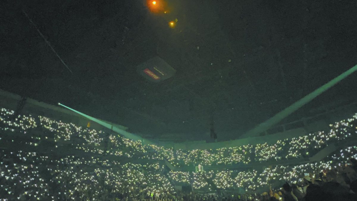 Light it up. In a breathing-taking display of unity, thousands of people illuminate the arena with phone lights at the CHI Health Center on March 16, 2022. The crowd transformed into a group of glowing white as the performance paused for an emotional moment at the “Happier than Ever” tour. “Concerts are more than just music; they’re moments where fans feel understood in various ways, energized and connected to something bigger than themselves,” senior Skyy Howard said. 