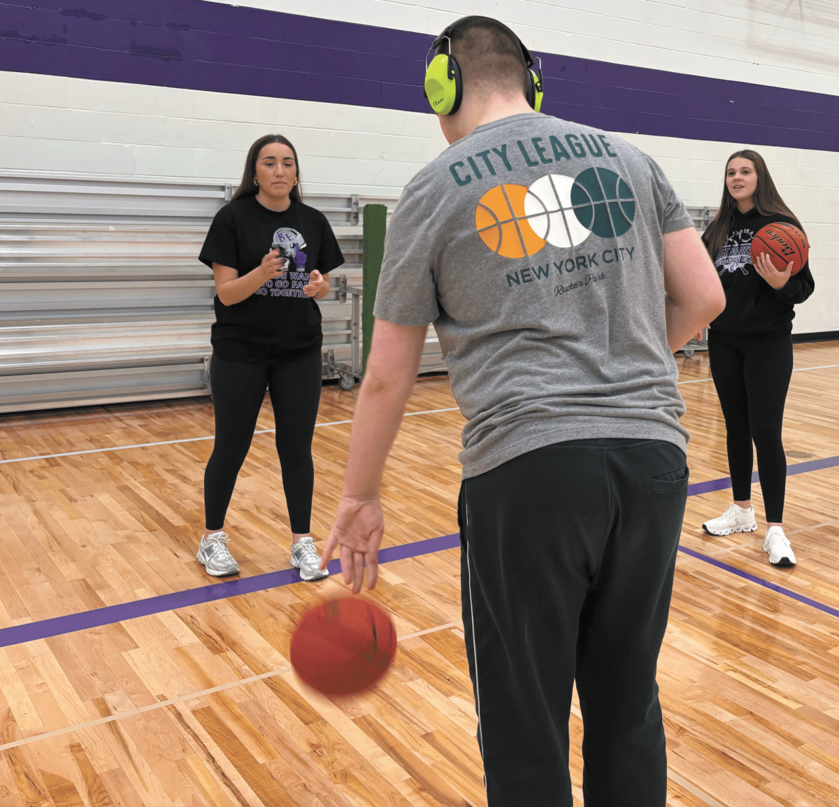 Guiding her team. Junior Myah McManigal speaks and gives advice to the players as they bounce their basketball. McManigal is a partner on the unified basketball team which is an important role as she assists the athletes. “My job as a partner is to help the kids understand what we are about to do, the exercises, and the plays.“ McManigal said.