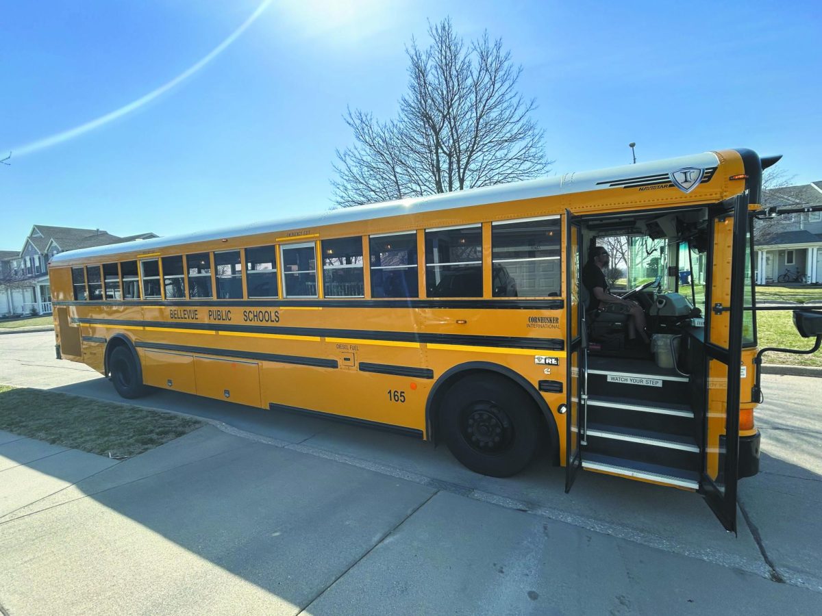 Hop on board. Picking up students from school to take them home, Paul Ysusi parks his bus at Bellevue East. Ysusi picks up students before and after school, as well as takes students to sporting events and other school activities. “I enjoy driving, especially a big bus,” Ysusi said. Photo by Savannah Stultz
