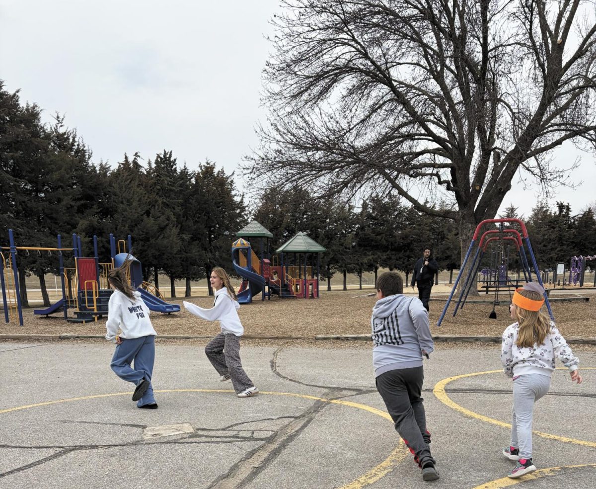 Tag, you are it. Playing a game with the elementary students at Wake Robin Elementary School, juniors Ava Salvino and Sydney Dickson run away, trying not to get tagged. They work for the Kids’ Time program and work with the students every day after school. “Both of them went here at Wake Robin so they are familiar with the school and program,” Kids’ Time Site Director Kenneth Scott said. “They are both amazing and always willing to help out.”