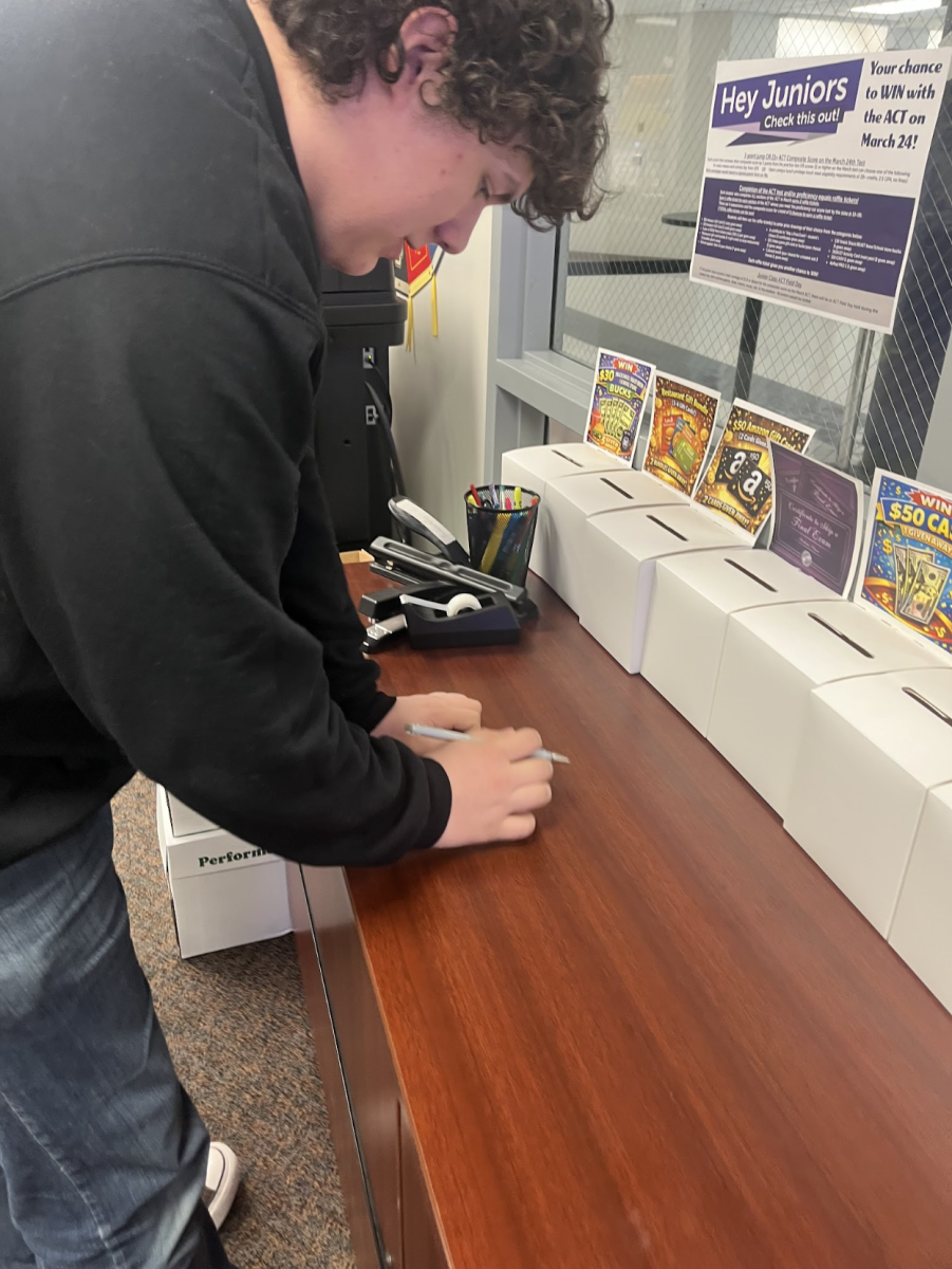 Writing quickly. Writing on tickets for Bellevue East’s ACT raffle, junior Conner Findley decides which prize he wants to win. In April of 2026, all Nebraska high school juniors took the state's standardized test in order to determine college readiness. “Some sections were easier, others were harder,” Findley said.